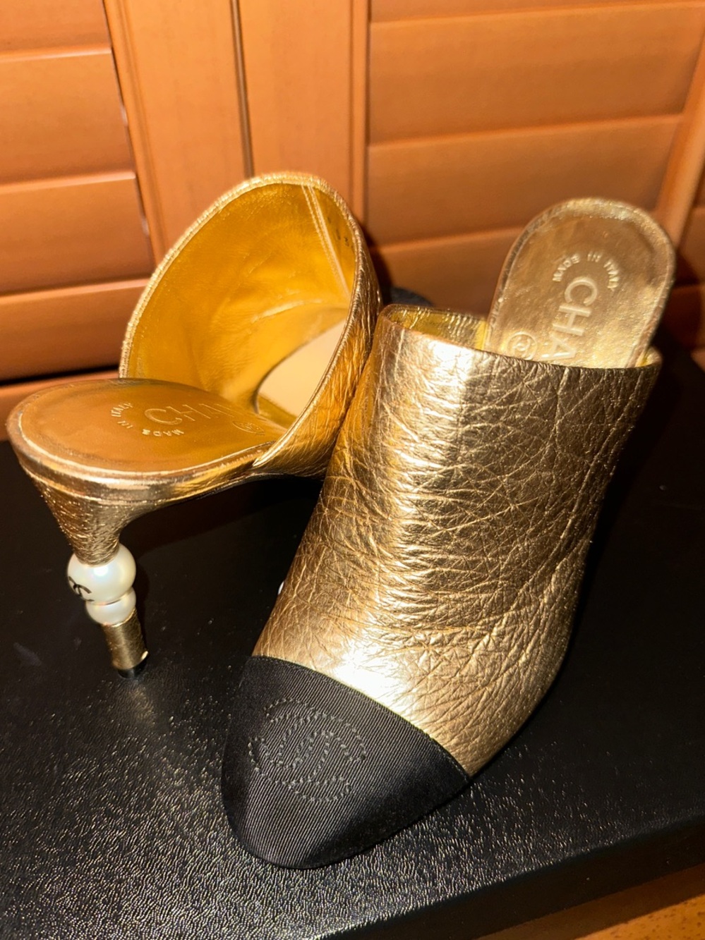 CHANEL Gold Leather Mules with Black Cap Toe and Pearl-Accented Heel